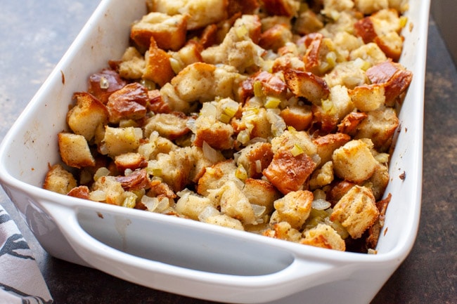 Before going into the oven close up of stuffing recipe in a white baking dish