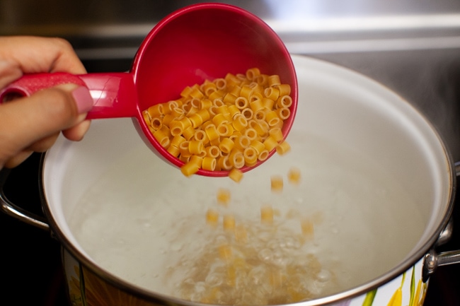 Spicy Chicken Soup from thelittlekitchen.net pasta being poured into a boiling pot of water