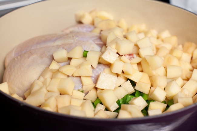 Spicy Chicken Soup from thelittlekitchen.net chopped russet potatoes in a pot with a whole chicken