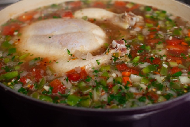 Spicy Chicken Soup from thelittlekitchen.net a whole chicken in a pot cooking with vegetables, parsley and spices