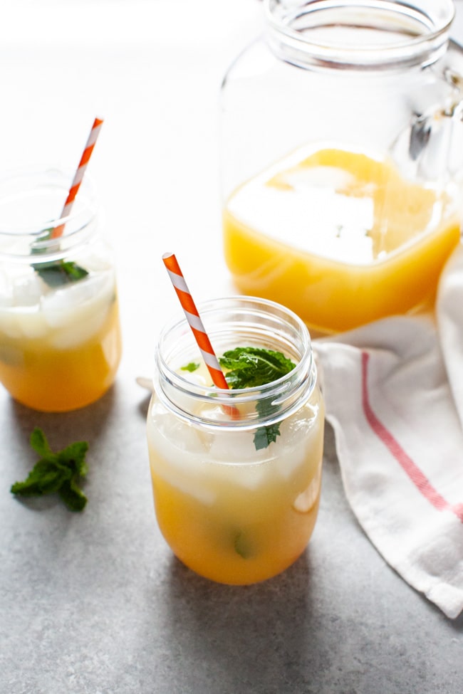 Orange Mint Tea from thelittlekitchen.net orange mint tea in a mason jar with a jug in the background