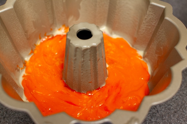 Rainbow Bundt Cake from thelittlekitchen.net Orange cake batter in Bundt cake pan