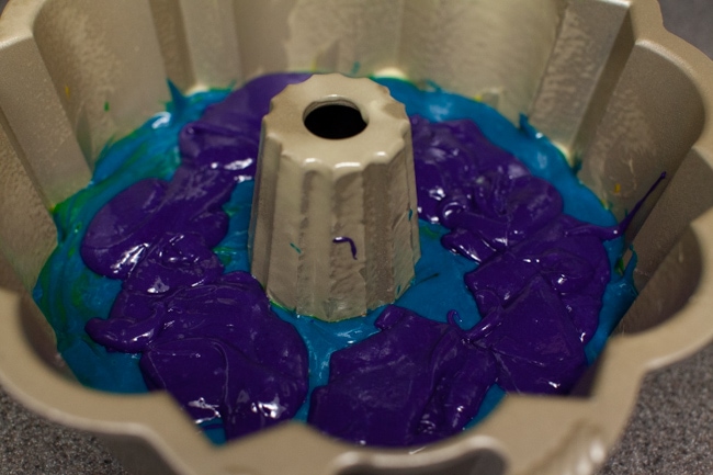 Rainbow Bundt Cake from thelittlekitchen.net Purple cake batter being poured on top of blue cake batter in Bundt cake pan