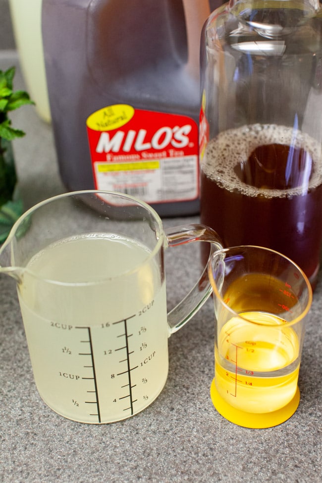 Sweet Tea with Vodka and Lemonade from thelittlekitchen.net lemonade in a measuring cup with vodka, sweet tea in a carrafe on a counter