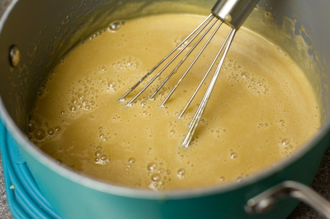 Whisking Sugar Pie filling in turquoise saucepan Whisking Sugar Pie filling in turquoise saucepan