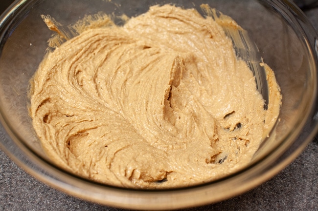 Peanut Butter Blossom Cookies from thelittlekitchen.net A mixture of peanut butter, shortening, sugar, and brown sugar in a glass bowl.