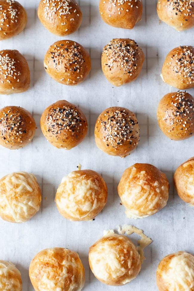 Stuffed Bagel Bites from thelittlekitchen.net rows of stuffed bagel bites with toppings on parchment paper