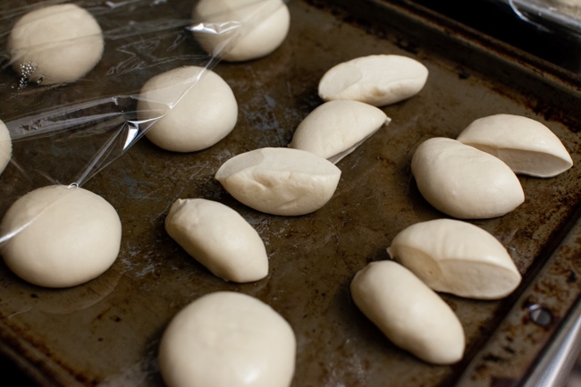 Stuffed Bagel Bites from thelittlekitchen.net Rhodes dinner rolls cut in half on a baking sheet