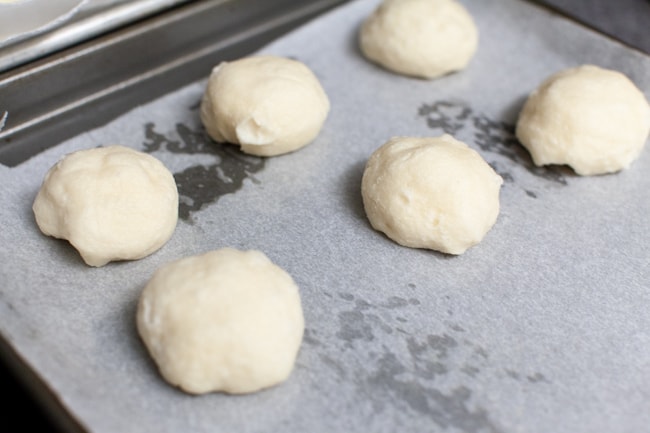 Stuffed Bagel Bites from thelittlekitchen.net stuffed bagel bites on a parchment paper lined baking sheet