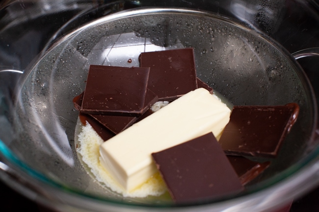 Heart Shape Chocolate Cake from thelittlekitchen.net chocolate bars and butter in a bowl on top of a pot