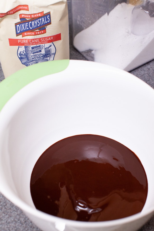 Heart Shape Chocolate Cake from thelittlekitchen.net melted chocolate in a mixing bowl with sugar in the background