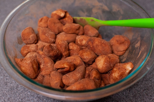Easy Monkey Bread with Nutella from thelittlekitchen.net dough balls that have been rolled in a cinnamon and sugar mixture sitting in a glass bowl.