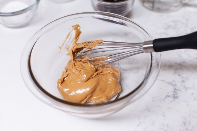 Peanut Sauce from thelittlekitchen.net peanut butter in a bowl with a whisk