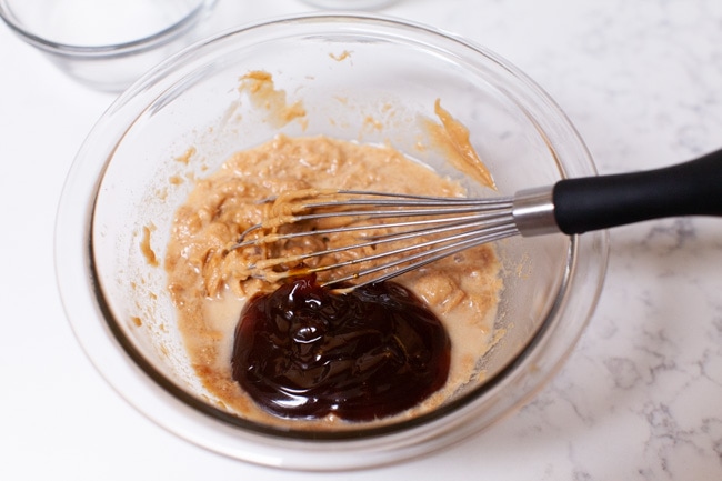 How to Make Peanut Sauce from thelittlekitchen.net making peanut sauce in a glass bowl with a whisk