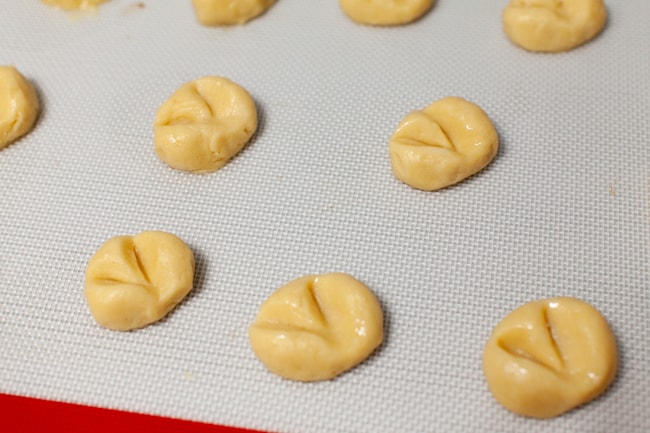 Heart-Shaped Thumbprint Cookies from thelittlekitchen.net heart shaped thumbprint cookies on a silicon baking mat