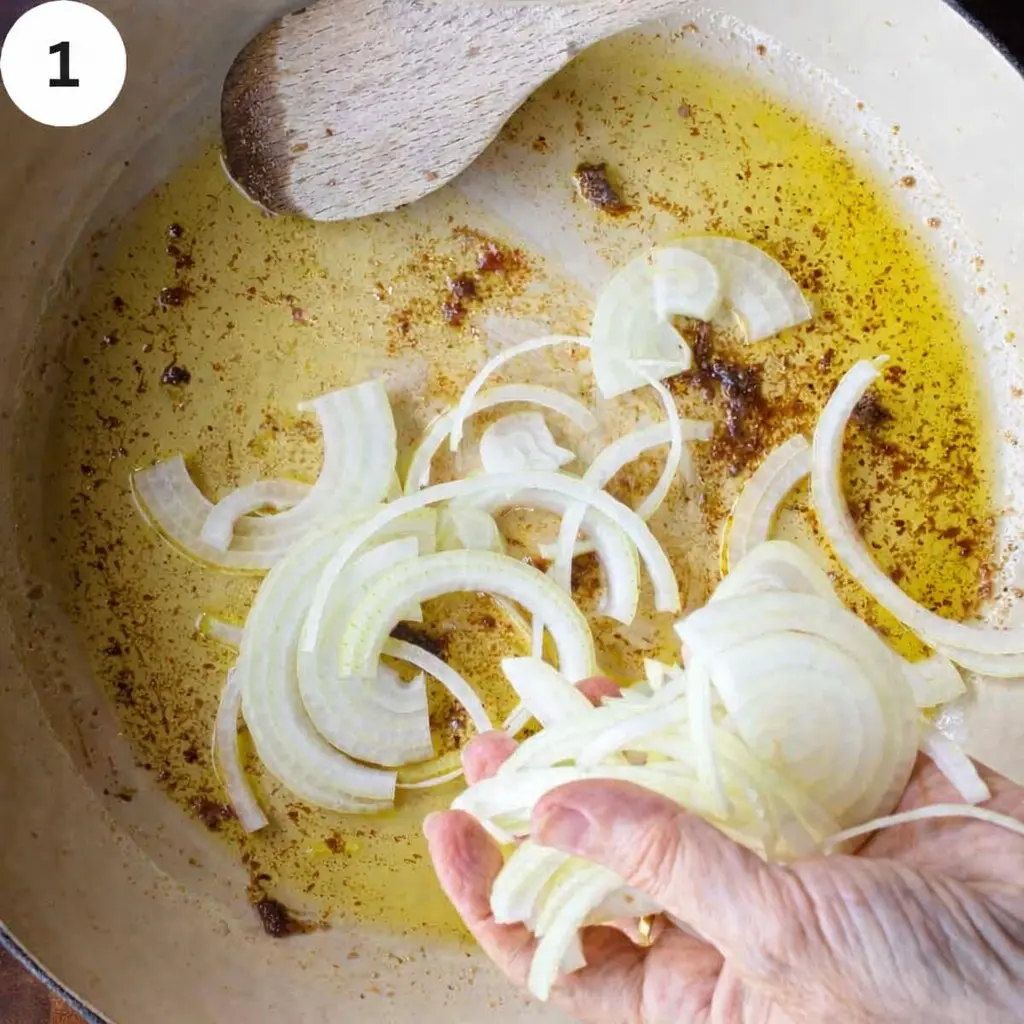 Dissolving anchovies and sautéing onions in skillet